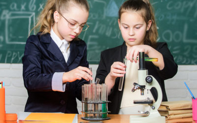 School experiment. Science concept. Gymnasium students with in depth study of natural sciences. Girls school uniform busy with proving their hypothesis. Private school. School project investigation
